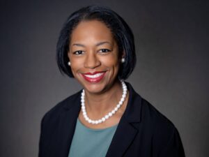 Headshot of Lisa Rayford Barrimond, Esq. She is an african-american woman wearing a black blazer, teal blouse and pearl necklace.